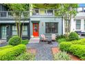 Charming entryway features a vibrant red door, cozy seating, and beautiful landscaping at 758 Cady Way, Atlanta, GA 30312