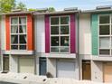 Modern townhome exterior with colorful accents and individual garage doors at 1356 Peter Haughton Nw Way, Atlanta, GA 30318