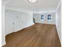 Open living space featuring hardwood floors, neutral paint, and multiple windows for natural light at 165 N River Dr # B, Atlanta, GA 30350