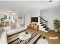 Bright living room featuring modern decor, hardwood floors and contemporary furnishings at 165 N River Dr # B, Atlanta, GA 30350