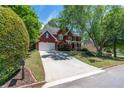 Well-maintained home with a long driveway and a lovely red brick facade at 4035 Regal Oaks Dr, Suwanee, GA 30024