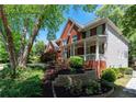 Beautifully landscaped yard with a classic red brick home and inviting front porch at 4035 Regal Oaks Dr, Suwanee, GA 30024