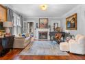 Bright living room with fireplace, hardwood floors, large windows, and stylish decor at 557 E Wesley Ne Rd, Atlanta, GA 30305