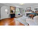Living room featuring hardwood floors, fireplace, many windows, and an arched white front door at 557 E Wesley Ne Rd, Atlanta, GA 30305