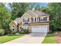 Charming two-story traditional home with well-manicured lawn, two-car garage and lush landscaping at 989 Pinfeather Ct, Lawrenceville, GA 30043