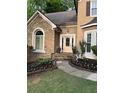 Beautiful stone and siding home with manicured landscaping and front door at 989 Pinfeather Ct, Lawrenceville, GA 30043