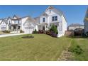 Attractive two-story home with a lush green lawn, colorful landscaping, and a long driveway at 146 Citrine Way, Acworth, GA 30101