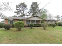 Inviting one-story brick home with green shutters, complemented by a well-maintained lawn and manicured landscaping at 3257 Greenvale Way, Decatur, GA 30034