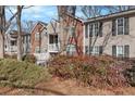 Multi-unit condo featuring red brick accents, neutral siding, and well-maintained landscaping at 384 Teal Ct, Roswell, GA 30076