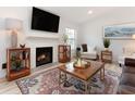 Inviting living room featuring a fireplace, large TV, and comfortable seating at 384 Teal Ct, Roswell, GA 30076