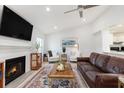 Bright living room with fireplace, vaulted ceiling, ceiling fan and hardwood flooring at 384 Teal Ct, Roswell, GA 30076