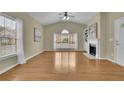 Bright living room boasting hardwood floors, a fireplace, and large windows at 509 Sawnee Corners Dr, Cumming, GA 30040