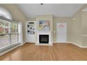 Inviting living room showcasing hardwood floors, fireplace, and large windows at 509 Sawnee Corners Dr, Cumming, GA 30040