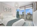 Cozy bedroom with a plush queen bed, skyline views from the large windows, and stylish decor create a serene urban retreat at 1080 Peachtree Ne St # 2515, Atlanta, GA 30309