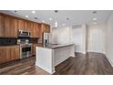 Contemporary kitchen with granite countertops, stainless steel appliances, an island with seating, and sleek cabinetry, adjacent to entryways at 1080 Peachtree Ne St # 2515, Atlanta, GA 30309