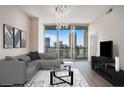 Stylish living room with contemporary furnishings, hardwood floors, and skyline views through expansive windows, perfect for urban living at 1080 Peachtree Ne St # 2515, Atlanta, GA 30309
