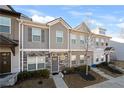 Inviting townhome with stone and siding exterior and well maintained lawn at 813 Ambient Sw Way, Atlanta, GA 30331