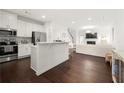 Open-concept kitchen and living area with hardwood floors and stainless steel appliances at 813 Ambient Sw Way, Atlanta, GA 30331