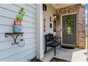 Inviting front porch with stylish decor, a bench, and a welcoming entrance with lemons at 6170 Weddington Dr, Cumming, GA 30040