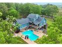 Stunning aerial view of property with large in-ground pool surrounded by lush trees, creating a private oasis at 65 Maude White Rd, Kingston, GA 30145