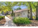 Exterior view of the property showcasing landscaping and mature trees at 1150 Collier Nw Rd # K18, Atlanta, GA 30318