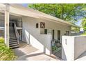 A well-maintained condo exterior with stairs leading to upper units and gated access at 1150 Collier Nw Rd # K18, Atlanta, GA 30318