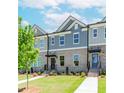 Inviting townhome with brick facade, neat landscaping, and a well-maintained lawn at 1262 Ainsworth Aly # 48, Sugar Hill, GA 30518