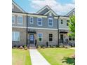 Attractive brick townhomes featuring well-kept lawns, sidewalks, and stylish entrances at 1262 Ainsworth Aly # 48, Sugar Hill, GA 30518