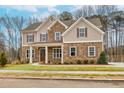Charming two-story home featuring a blend of brick and siding, well-manicured lawn, and inviting front entrance at 3390 Hillshire Dr, Cumming, GA 30028