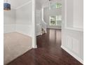 Inviting entryway featuring dark hardwood floors, carpeted dining room and a view into the living area at 145 Redsage Rdg, Atlanta, GA 30349