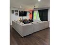 Living room featuring a large sectional sofa, dark wood floors and recessed lighting at 2874 Cloverleaf Se Dr, Atlanta, GA 30316