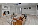 Bright living room with a white painted brick fireplace, modern furniture and light hardwood flooring at 780 N Ola Rd, Mcdonough, GA 30252