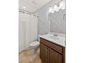 Cozy bathroom with a shower, single sink vanity, and bright lighting at 123 Academy Ln, Canton, GA 30114