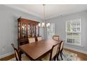 This dining room features a classic wooden table, hutch, and chandelier under a tray ceiling at 123 Academy Ln, Canton, GA 30114