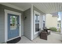Inviting front porch features comfortable seating and a stylish blue front door at 123 Academy Ln, Canton, GA 30114