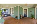 Cozy front porch with swing, seating and stained wood floors at 167 E Lake Se Ter, Atlanta, GA 30317