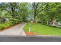 Long driveway leading to a home nestled among lush trees at 2700 Brook Park Way, Doraville, GA 30340