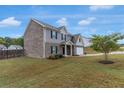 Two-story home with brick and siding exterior, manicured lawn, and an attached garage at 436 Vermeer Ct, Locust Grove, GA 30248