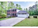 Two-story brick home with an attached two-car garage and a long concrete driveway at 5083 Lambeth Nw Ct, Acworth, GA 30101