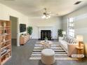 Bright living room with fireplace, ceiling fan, and large window dressed with stylish furniture at 5537 Panola Pl, Lithonia, GA 30058