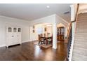 Elegant dining area with hardwood floors, staircase, and classic furnishings for memorable gatherings at 637 Little Bear Loop, Canton, GA 30114
