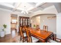 Elegant dining room with coffered ceilings, hardwood floors, and a stylish china cabinet at 637 Little Bear Loop, Canton, GA 30114