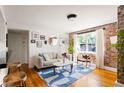 Cozy living room featuring exposed brick, a modern sofa, and hardwood flooring at 24 Daniel Se St # 3, Atlanta, GA 30312