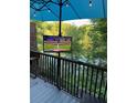 Outdoor entertainment area with a flat-screen TV and wooded water views at 3812 Stonewall Se Ter, Atlanta, GA 30339