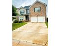Charming two-story home with a brick facade and a well-maintained front yard at 573 Emporia Loop, Mcdonough, GA 30253