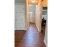 Inviting hallway with wood-look flooring and natural light from the front door at 573 Emporia Loop, Mcdonough, GA 30253