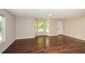 Bright living area boasts hardwood floors, a large window, and a neutral color scheme at 7307 Banks Mill Rd, Douglasville, GA 30135