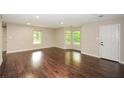 Spacious living room featuring hardwood floors, natural light, and neutral wall colors at 7307 Banks Mill Rd, Douglasville, GA 30135