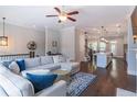 Spacious living room with an open concept view into the kitchen, beautiful floors, and a large comfortable couch at 1382 Doublegate Ne Dr, Atlanta, GA 30319