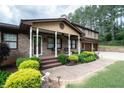 Inviting front porch with brick walkway, decorative plants, and ample seating at 204 Mt Moriah Rd, Auburn, GA 30011